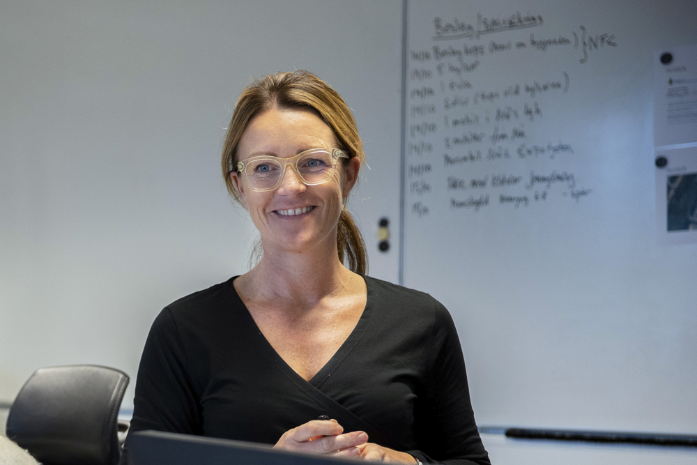 Anna Bergkvist står framför en whiteboard. Foto.