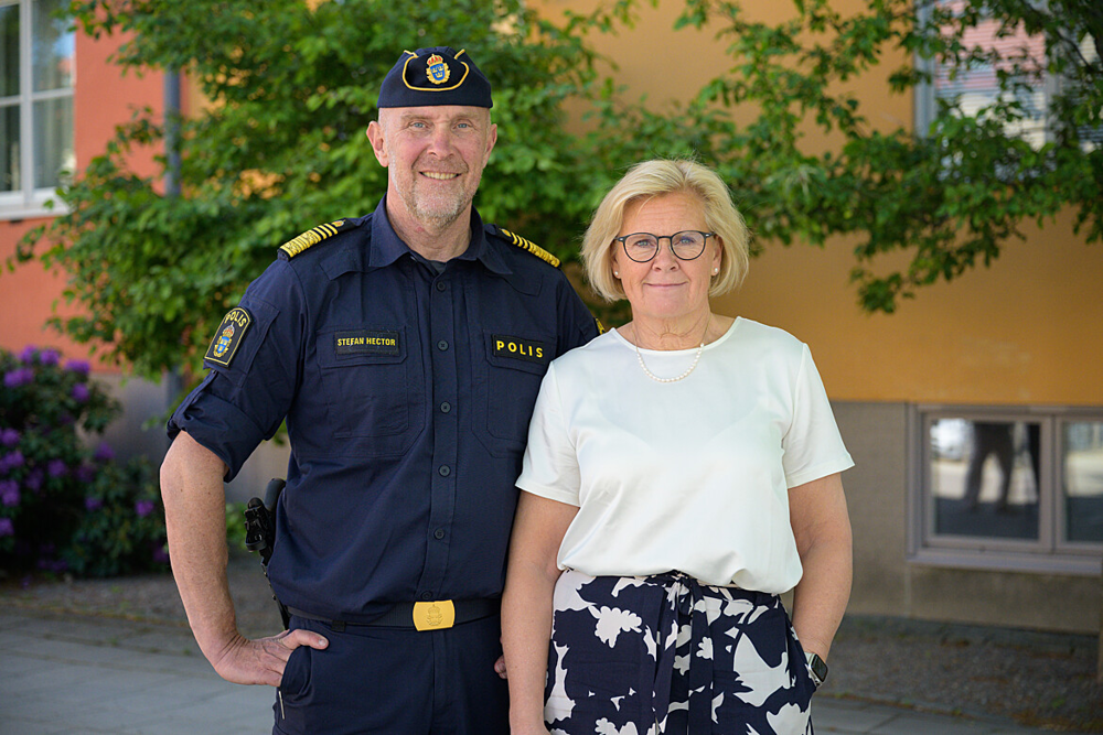 Stefan Hector, biträdande rikspolischef, och Petra Lundh, rikspolischef, utomhus med grönskande träd. Foto.